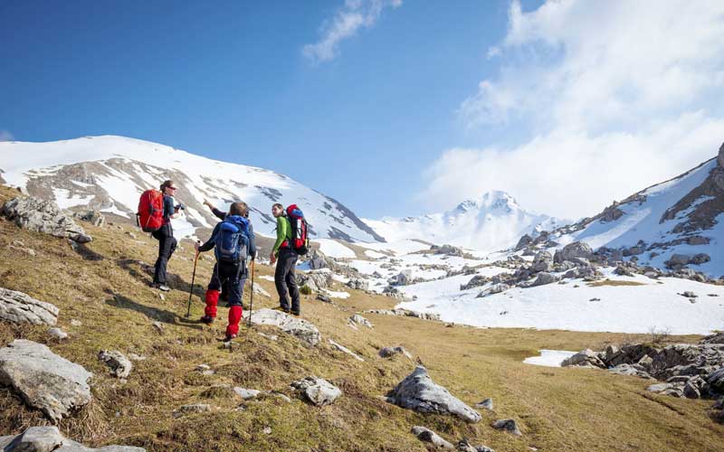 Group of hikers, snow mountain in background 